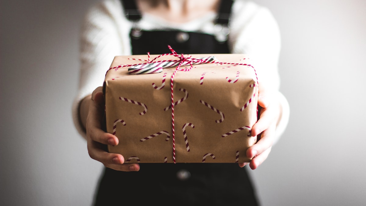 Holiday festive gift box with ribbon representing 13th month year-end bonus